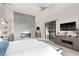 Modern main bedroom featuring a fireplace, flat-screen TV, and a sliding glass door for seamless indoor-outdoor living at 5 Moonfire Dr, Las Vegas, NV 89135