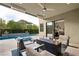 Inviting outdoor living space with a pool, a cozy fire pit, and comfortable seating for relaxing and entertaining at 5 Moonfire Dr, Las Vegas, NV 89135