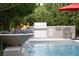 Backyard pool with water feature and outdoor kitchen, including a grill, perfect for entertaining and enjoying outdoor living at 5 Moonfire Dr, Las Vegas, NV 89135