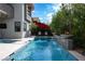 Stunning pool area with a sleek, modern design, fire features, and lush landscaping for a tranquil retreat at 5 Moonfire Dr, Las Vegas, NV 89135
