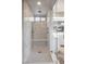 Luxurious walk-in shower with marble tile, a built-in bench, and modern fixtures creating a spa-like experience at 5 Moonfire Dr, Las Vegas, NV 89135