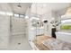 Luxurious walk-in shower with marble tile, a built-in bench, and modern fixtures creating a spa-like experience at 5 Moonfire Dr, Las Vegas, NV 89135
