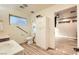 Clean bathroom with a sink, toilet, and a cabinet, complete with accessibility features and light wood floors at 517 7Th St, Boulder City, NV 89005