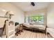 Bedroom features a large window for natural light, complemented by light wood floors and neutral wall colors at 517 7Th St, Boulder City, NV 89005