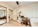 Bright bedroom with light wood floors, a ceiling fan, closet with mirror doors and a view into other rooms at 517 7Th St, Boulder City, NV 89005
