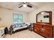 Bedroom with light wood floors, a window with a view, and furniture including a dresser with an attached mirror at 517 7Th St, Boulder City, NV 89005