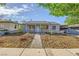 Inviting single-story home featuring a rock garden and a concrete walkway to the front door at 517 7Th St, Boulder City, NV 89005