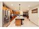 Spacious kitchen featuring an island with barstools, stainless steel appliances, and hardwood flooring at 517 7Th St, Boulder City, NV 89005