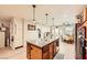 Bright kitchen with large granite island, stainless appliances, hardwood floors, and a view to the breakfast nook at 517 7Th St, Boulder City, NV 89005