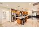 Well-equipped kitchen with stainless appliances, granite island with bar seating, and hardwood floors at 517 7Th St, Boulder City, NV 89005