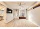 Neutral living space with wood-look floors, ceiling fan, and access to bathroom at 517 7Th St, Boulder City, NV 89005