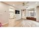 Bright living room with wood-look floors, ceiling fan, and access to bathroom at 517 7Th St, Boulder City, NV 89005