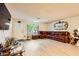 Open living room featuring laminate flooring, a vintage door, and ample natural light at 517 7Th St, Boulder City, NV 89005