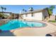 Private backyard featuring a sparkling pool, covered patio, and lush landscaping at 5181 Morris St, Las Vegas, NV 89122