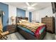 This bedroom features blue accent wall, a ceiling fan, and dresser storage at 5181 Morris St, Las Vegas, NV 89122