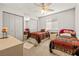 Bright bedroom with two twin beds, mirrored closet, and a ceiling fan at 5181 Morris St, Las Vegas, NV 89122