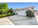 Attached two-car garage showcasing the driveway and landscaping at 5181 Morris St, Las Vegas, NV 89122