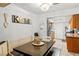 Eat-in kitchen area featuring a dining table with bench seating and modern lighting at 5181 Morris St, Las Vegas, NV 89122
