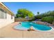 Private backyard pool area with lush greenery, rock accents, and a serene atmosphere at 5181 Morris St, Las Vegas, NV 89122