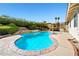 Inviting backyard pool with rock waterfall feature, landscaped surroundings, and shaded patio at 5181 Morris St, Las Vegas, NV 89122