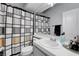 Neutral bathroom featuring a single sink, large mirror, and a shower-tub combination with patterned curtain at 5221 Tropical Peach Dr, Las Vegas, NV 89118