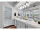 Bright bathroom boasts dual sinks, large mirrors, updated fixtures, and a shower-tub combo at 5221 Tropical Peach Dr, Las Vegas, NV 89118
