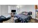 Cozy bedroom with dark wood floors, large window with shutters and beanbag chair at 5221 Tropical Peach Dr, Las Vegas, NV 89118