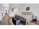 Cozy bedroom with hardwood floors, black metal bedframe, ensuite and plush ottoman at 5221 Tropical Peach Dr, Las Vegas, NV 89118