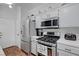 Cozy kitchen with stainless steel appliances, white cabinets and wood flooring at 5221 Tropical Peach Dr, Las Vegas, NV 89118