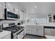 Well-lit kitchen featuring white cabinets, a gas range, and stainless steel appliances at 5221 Tropical Peach Dr, Las Vegas, NV 89118