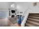 Living room with fireplace, built-in shelving, and stairs with white railing at 5221 Tropical Peach Dr, Las Vegas, NV 89118