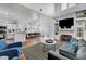 Bright living room featuring a fireplace, open to the kitchen and dining area at 5221 Tropical Peach Dr, Las Vegas, NV 89118