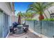 Outdoor patio with stone floor, umbrella-covered table with seating and grill at 5221 Tropical Peach Dr, Las Vegas, NV 89118
