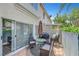 Outdoor patio with stone floor, umbrella-covered table with seating, and grill seen through sliding glass door at 5221 Tropical Peach Dr, Las Vegas, NV 89118