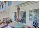A charming patio featuring a glass table, upholstered furniture, grill and sliding door at 5221 Tropical Peach Dr, Las Vegas, NV 89118