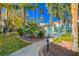 Landscaped walkway leading to a gated community pool with lush greenery and tall palm trees at 5221 Tropical Peach Dr, Las Vegas, NV 89118