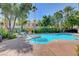Community pool surrounded by lounge chairs and palm trees in a tropical resort-style setting at 5221 Tropical Peach Dr, Las Vegas, NV 89118