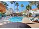 Well-maintained community pool with palm trees, lounge chairs, and a shaded structure at 5221 Tropical Peach Dr, Las Vegas, NV 89118
