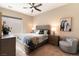 Comfortable bedroom features a large bed, side tables, a decorative chair, and natural light from a window at 5436 Succulent Rose Dr, Las Vegas, NV 89135