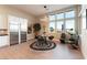 Breakfast nook with stainless steel refrigerator, a round table with modern lighting, and large windows at 5436 Succulent Rose Dr, Las Vegas, NV 89135