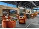 Clubhouse interior with a seating area with chairs, a large TV, and a kitchen counter with chairs at 5436 Succulent Rose Dr, Las Vegas, NV 89135