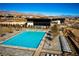 Beautiful community pool featuring crystal-clear water, comfortable lounge chairs, and modern clubhouse in the background at 5436 Succulent Rose Dr, Las Vegas, NV 89135