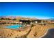 Inviting community pool with mountain views, surrounded by landscaped grounds and modern amenities for relaxation at 5436 Succulent Rose Dr, Las Vegas, NV 89135