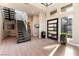 Bright foyer featuring modern staircase, high ceilings, stylish decor, and large windows for plenty of natural light at 5436 Succulent Rose Dr, Las Vegas, NV 89135