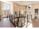 Bright open foyer with high ceilings, a modern railing staircase, hardwood floors, and many large windows at 5436 Succulent Rose Dr, Las Vegas, NV 89135
