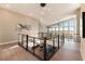 Spacious second floor hallway with hardwood floors, large windows and modern railing staircase at 5436 Succulent Rose Dr, Las Vegas, NV 89135