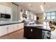 Modern kitchen with granite countertops, a center island with bar seating, and white cabinetry at 5436 Succulent Rose Dr, Las Vegas, NV 89135