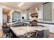 Gourmet kitchen boasts a large island with seating, granite countertops, and stainless steel appliances at 5436 Succulent Rose Dr, Las Vegas, NV 89135