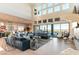 Spacious living room with floor-to-ceiling windows, a comfortable sofa, and views of the outdoor pool at 5436 Succulent Rose Dr, Las Vegas, NV 89135