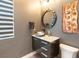 Contemporary powder room features a stylish vanity, vessel sink, decorative mirror and modern lighting at 5436 Succulent Rose Dr, Las Vegas, NV 89135